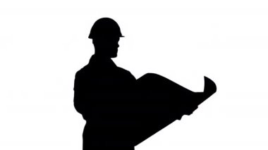 Silüet mühendisi, mimar, müteahhit, iş adamı, elinde projeyle beyaz bir kask takıyor, objeye bakıyor ve dans ediyor..