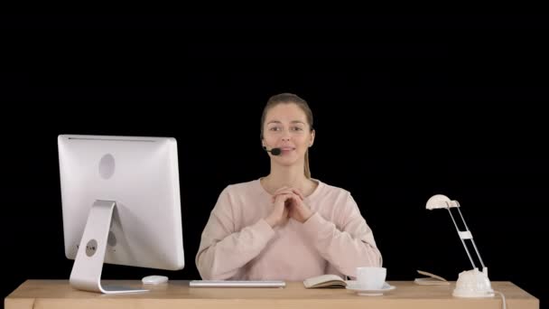 Happy young woman in headset looking at camera and talking, Alpha Channel — Stock Video