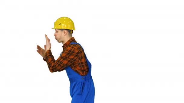 Construction worker willing to work, ready to work He claps hands and makes cool flip then smiles to camera on white background. — Stock Video