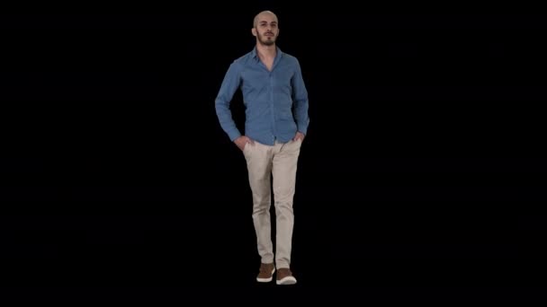 Hombre árabe joven guapo usando un traje casual caminando, poniendo sus dos manos en sus bolsillos, Alpha Channel — Vídeo de stock
