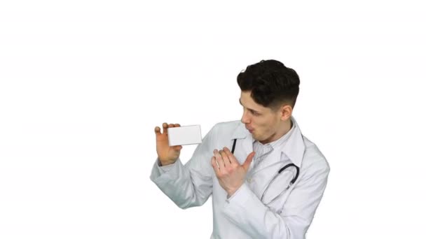 Young doctor presenting new pills and dancing on white background. — Stock Video