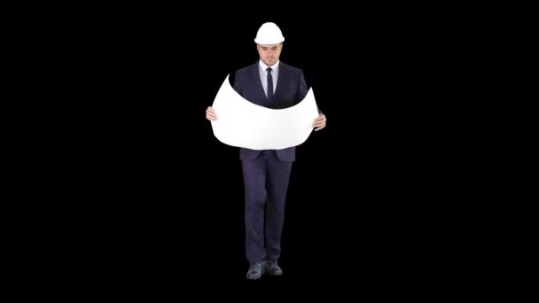 Professional architect is walking and holding blueprint The man is wearing helmet, Alpha Channel — Stock Video