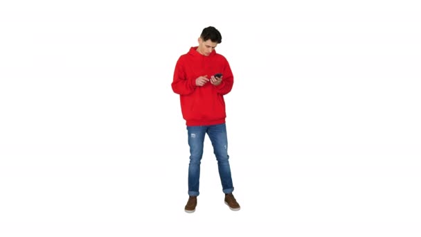 Successful young casual man receiving good news on the phone and dancing after this on white background. — Stock Video