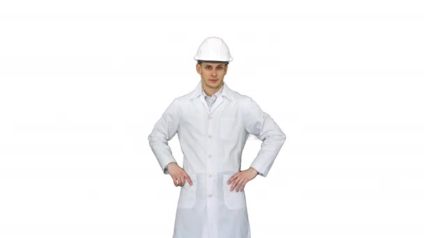 A young engineer putting dafety hat on on white background. — Stock Video