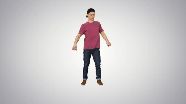 Caucasian man rapper does some stylish light dancing on gradient background. — Stock Video
