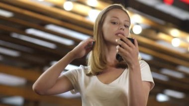 Genç, tatlı bir kadın saçını dışarıda tarıyor..