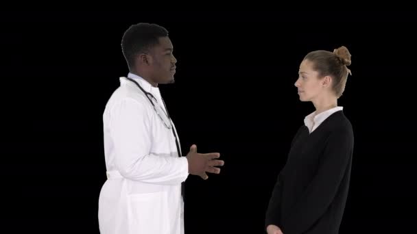 Male african doctor talking to female patient, Alpha Channel — Stock Video