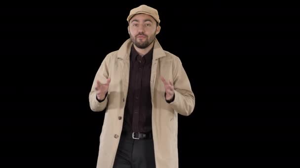 Charming man in trench coat walking and talking to camera, Alpha Channel — Stock Video