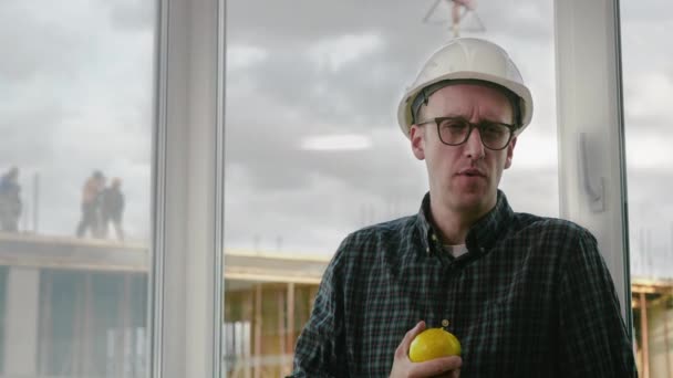 Construction worker eating an apple. — Stock Video