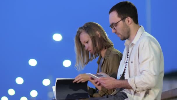 Attractive Couple using Tablet Computer Outdoors. — Stock Video