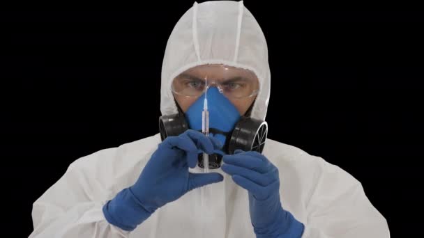 Scientist in protective gear holding syringe with injection, Alpha Channel — Stock Video