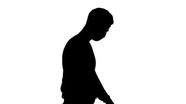 Silhouette Young handsome man walking with medical mask on. — Stock Photo, Image