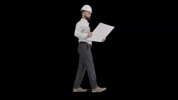 Young construction architect walking looking at blueprint, Alpha Channel — Stock Video