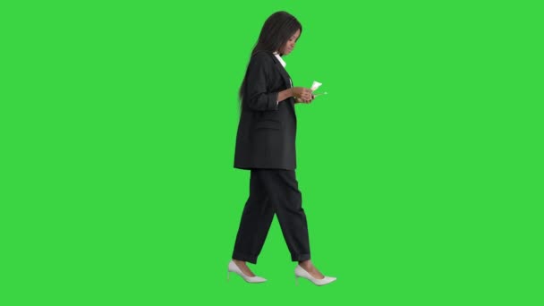 緑の画面、クロマキーを歩いている間にお金を数える幸せなアフリカ系アメリカ人女性. — ストック動画