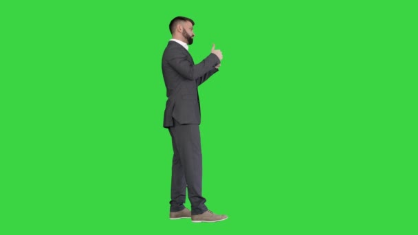 Стильный красивый бородатый мужчина с большим пальцем вверх на зеленом экране, хромированный ключ. — стоковое видео