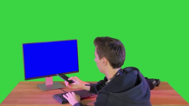 Jogador ou hacker respondendo a um telefonema em uma tela verde, Chroma Key. — Vídeo de Stock