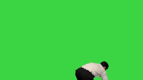 Jeune homme habillé en chemise blanche et pantalon noir dansant break dance et souriant à la caméra à la fin sur un écran vert, Chroma Key. — Video
