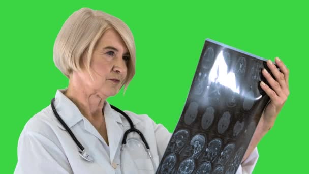 Ανώτερος γιατρός γυναίκα κοιτάζοντας Mri σε μια πράσινη οθόνη, Chroma κλειδί. — Αρχείο Βίντεο