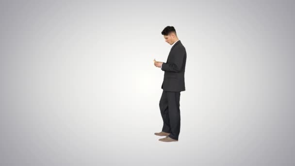 Young happy businessman dancing after counting salary Win dance on gradient background. — Stock Video