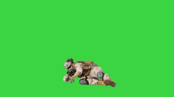 Soldier firing from lying position on a Green Screen, Chroma Key. — Stock Video