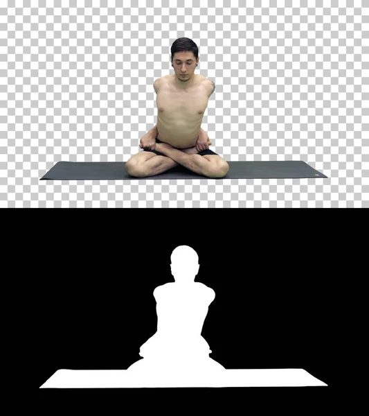 Sporty beautiful young man practicing yoga, sitting cross-legged in Adho Mukha Padmasana, bending forward in variation of Lotus Pose, Alpha Channel