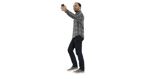 Šťastný úsměv chůze hezký vousatý mladý muž dělat selfie na bílém pozadí. — Stock fotografie