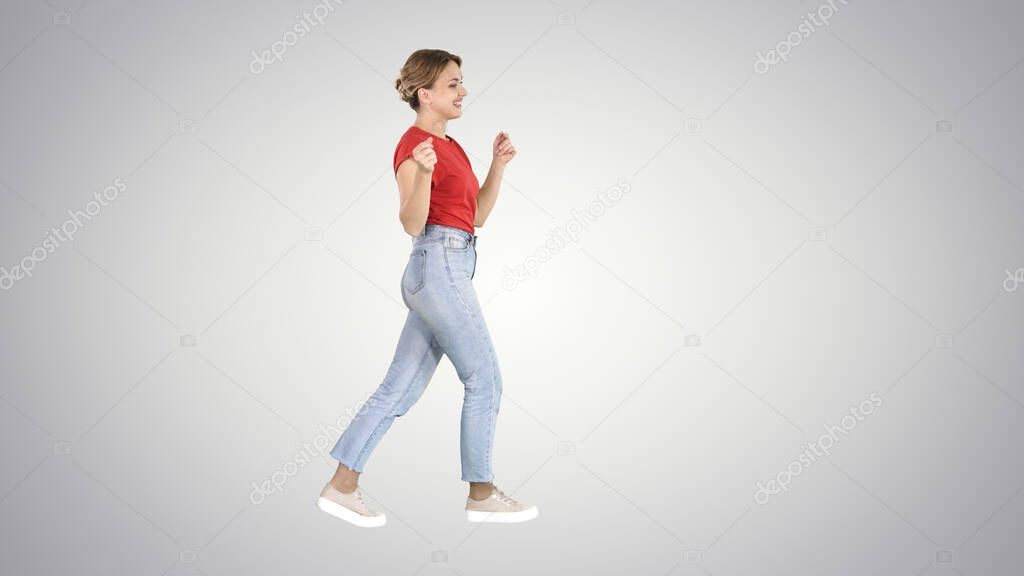 Happy smiling woman dancing and having fun on gradient background.