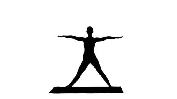 Silhuett Kvinna utövar yoga, stående i Extended Side Angle motion, Utthita parsvakonasana pose — Stockfoto