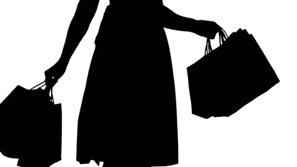 Silhouette Femme tenant des sacs à provisions dans ses mains et faisant un tour. — Photo