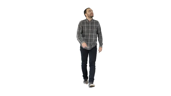 Young man walking looking up fascinated on white background. — Stock Photo, Image