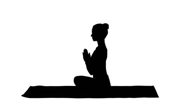 Silhouette Junge sportlich attraktive Frau praktiziert Yoga, macht Lotus-Pose. — Stockfoto