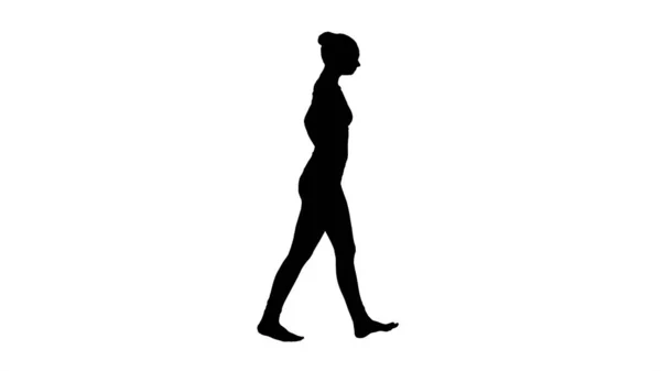 Sylwetka Piękna młoda kobieta rozciągająca szyję spacerując. — Zdjęcie stockowe