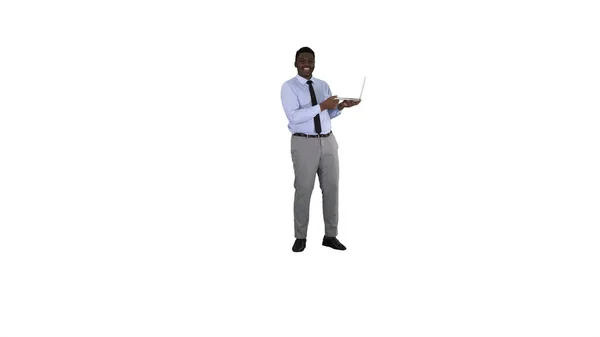 Talking to camera young african man with laptop in his hands on white background. — Stock Photo, Image