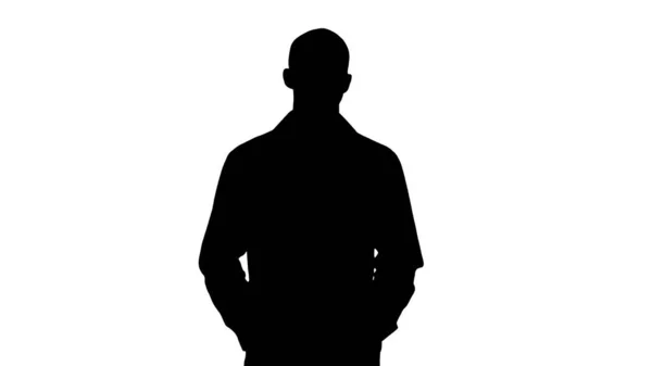 Silhouette Arab handsome doctor wearing his uniform walking with hands in pockets. — Stock Photo, Image