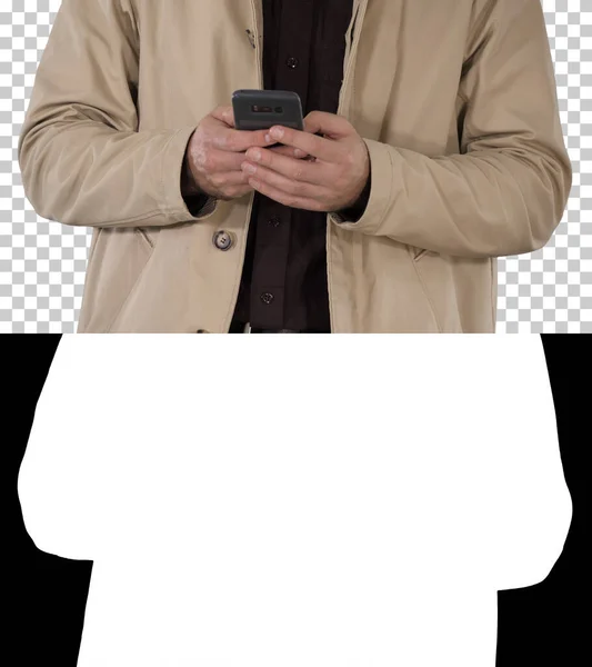 Man in trench coat using mobile smart phone, Alpha Channel — Stock Photo, Image