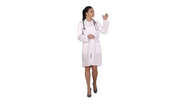 Female doctor showing something with hands extended Presentation on white background. — Stock Photo, Image