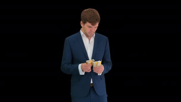 Happy businessman counting money and tucking it inside a jacket pocket, Alpha Channel — Stock Video