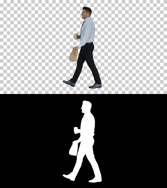 Businessman walking with take away coffee and paper bag with lunch, Alpha Channel