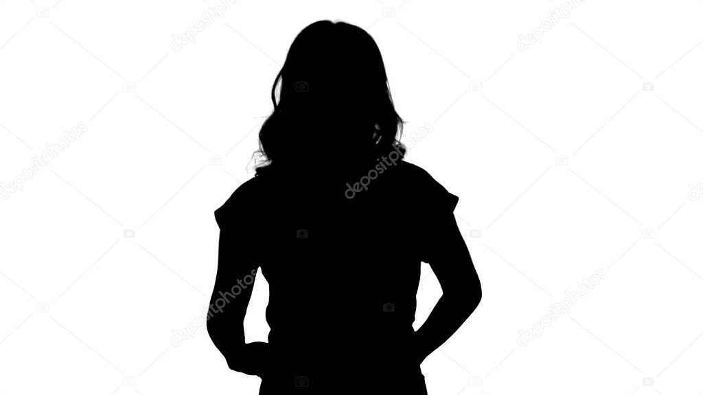 Silhouette Emotional happy and positive beautiful young woman talking and walking with hands in pockets.