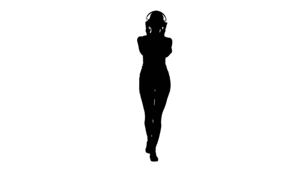 Silhouette Sportvrouw die muziek luistert in een hoofdtelefoon. — Stockfoto