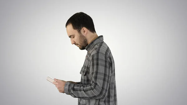 Tablet computer Side view of man using digital tablet on gradient background.