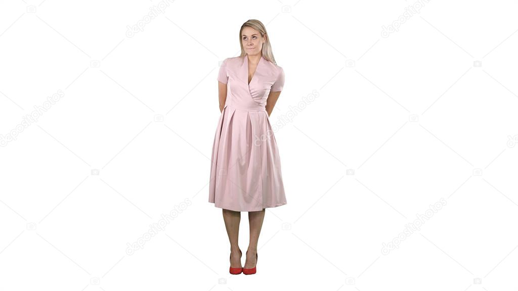 Portrait of fashion smilling young beautiful woman model posing in pink dress on white background.