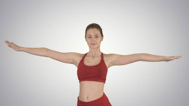 Fitness modeli Utthita parsvakonasana gradyan arka planda poz vermeye hazırlanıyor.