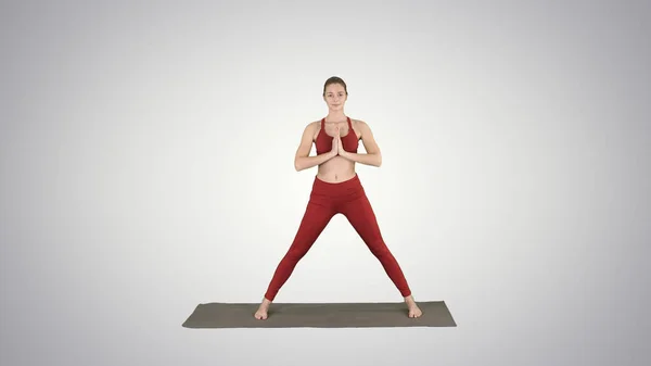 Wanita muda berlatih yoga, selesai melakukan latihan Utthita parsvakonasana dengan latar belakang gradien. — Stok Foto