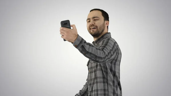 Teenage boy making a selfie when walking on gradient background. — Stock Photo, Image