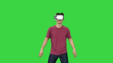 VR gözlüklü sıradan bir adam video oyunu oynuyor Yeşil Ekran, Chroma Key 'de Acemiler seviyesinde.