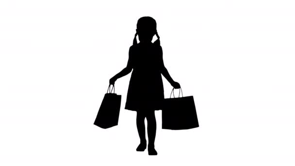 Siluet Siyah elbiseli güzel küçük kız alışveriş çantalarıyla yürüyor. — Stok video