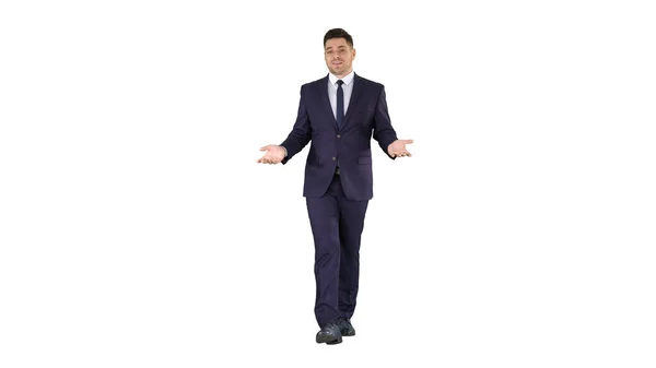 Businessman walking and explaining something to camera on white background. — Stock Photo, Image