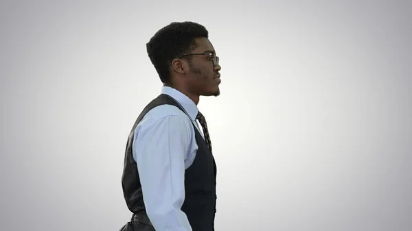 Young African American business man in glasses walking confident