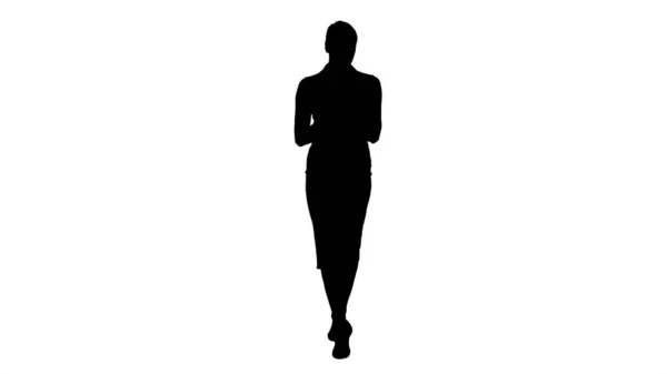 Silhouette Woman typing write message on smart phone and walking — Stock Photo, Image